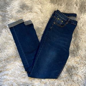 Stretchy blue jeans cuffed straight leg